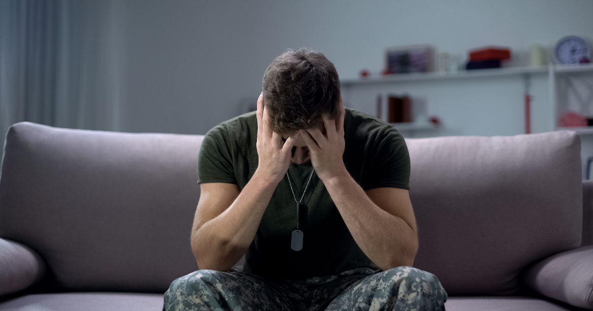 man in military uniform with head in hands sad - dyslexia treatment in Solana Beach CA